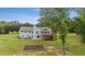 Spacious backyard with deck, patio, and lush greenery; perfect for outdoor living at 289 Barn Rd, Canton, GA 30115