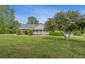 Well-maintained front yard with a covered front porch and manicured landscaping at 289 Barn Rd, Canton, GA 30115