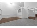 Spacious living room with elegant wainscoting, neutral carpet, and an open staircase at 7601 Watson Cir, Locust Grove, GA 30248