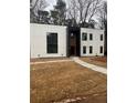 Modern home with white siding, black trim, and minimalist design offers a sleek and contemporary curb appeal at 2719 Winding Ne Ln, Brookhaven, GA 30319