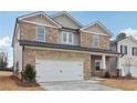 Two-story house with stone accents and a large front yard at 3913 Brushy St, Powder Springs, GA 30127
