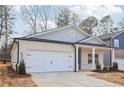 Two-story craftsman home with gray siding and a white brick base at 3933 Brushy St, Powder Springs, GA 30127