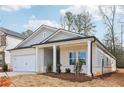 Single story home with gray siding, white brick, and a covered porch at 3933 Brushy St, Powder Springs, GA 30127