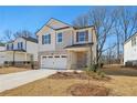 Two-story house with light-colored brick and a two-car garage at 4755 Marjorie Dr, Cumming, GA 30041