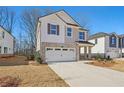 Two-story home with a two-car garage and front yard at 4755 Marjorie Dr, Cumming, GA 30041