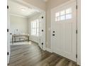 Bright entryway with hardwood floors, leading to a sunlit home office with french doors at 30 Pinewood Dr, Covington, GA 30014