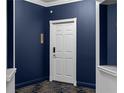 Unit entry door in a freshly painted navy hallway, framed by white trim and with new carpeting at 199 14Th St # 3003, Atlanta, GA 30309