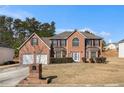 Beautiful two-story brick home with a well-maintained lawn and a two-car garage at 6849 Fireside Ln, Atlanta, GA 30349