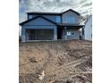 New two-story home with a gray brick facade, two-car garage and unfinished landscaping at 126 Henley St, Canton, GA 30114