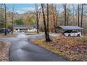 House with carport and paved driveway, nestled in a wooded area at 3465 Callie Still Rd, Lawrenceville, GA 30045