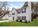 Two-story house with white siding, two-car garage, and landscaping at 4235 Waldrop Hills Ter, Decatur, GA 30034