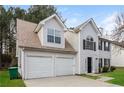 Two-story house with white siding, two-car garage, and landscaping at 4235 Waldrop Hills Ter, Decatur, GA 30034