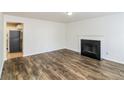Living room with hardwood floors, fireplace, and view of kitchen at 4235 Waldrop Hills Ter, Decatur, GA 30034