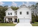 Charming two-story modern farmhouse featuring a two-car garage, covered porch, and board and batten siding at 106 Henley St, Canton, GA 30114