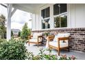 Inviting front porch featuring brick accents and comfortable seating, perfect for enjoying the outdoors at 106 Henley St, Canton, GA 30114
