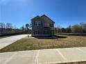 New construction with gray siding and brick accents, complemented by a long driveway and green lawn at 1641 Fuma Leaf Way, Mcdonough, GA 30253