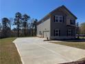 Two-story home with gray siding and a spacious driveway, set in a residential community at 1641 Fuma Leaf Way, Mcdonough, GA 30253