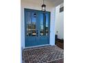 Teal double front doors with glass panels and brick walkway at 683 Summitt Hill Way, Cumming, GA 30040