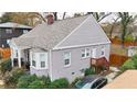 Gray painted brick home with an addition, mature landscaping, and new roof at 91 Morris Brown Sw Dr, Atlanta, GA 30314