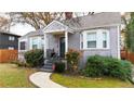 Landscaped front yard with a brick home, shrubbery, and a curved sidewalk at 91 Morris Brown Sw Dr, Atlanta, GA 30314