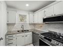 This kitchen features stainless steel appliances, white cabinets, a double sink, and granite countertops at 5400 Roswell Rd # C3, Atlanta, GA 30342