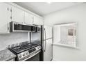 This kitchen features a stainless steel gas range, a stainless steel refrigerator, and granite countertops at 5400 Roswell Rd # C3, Atlanta, GA 30342