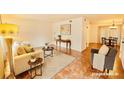 Bright living room featuring a comfortable sofa, stylish decor, and a cozy dining area at 2705 Greystone Pl, Austell, GA 30106