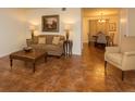 Cozy living room featuring tile floors, a comfortable sofa, and a dining area in the background at 2705 Greystone Pl, Austell, GA 30106