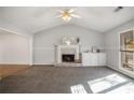 Bright living room with a charming fireplace, neutral paint and plush carpeting at 370 Charlyne Way, Dacula, GA 30019