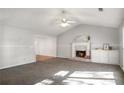 Bright living room with a charming fireplace, neutral paint and plush carpeting at 370 Charlyne Way, Dacula, GA 30019