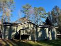 View of the back exterior elevation showing siding and a private deck with stairs at 4212 Anneewakee Rd, Douglasville, GA 30135
