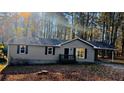 Cozy single-level home showcasing a welcoming front porch and convenient carport at 4212 Anneewakee Rd, Douglasville, GA 30135