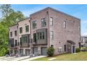 Back view of newly built townhomes with garages and small balconies on the second floor at 822 Urban Grange Way, Suwanee, GA 30024