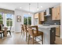 Modern kitchen featuring an island with seating, stainless steel appliances, and wood flooring at 913 Echo Park Dr, Suwanee, GA 30024
