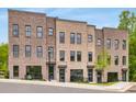 Attractive townhome showcasing a brick facade with modern windows and inviting entrances on a well-maintained street at 923 Echo Park Dr, Suwanee, GA 30024