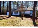 Charming one-story home features white exterior, landscaping, and a tree-lined setting at 204 Apple Branch Dr, Woodstock, GA 30188