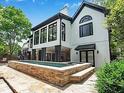 Beautiful backyard pool area with stone accents, stone patio, and a covered porch at 220 Windsor Gate Ne Cv, Atlanta, GA 30342