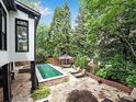 Gorgeous pool with surrounding lounge area, pergola, and lush landscaping in the backyard at 220 Windsor Gate Ne Cv, Atlanta, GA 30342