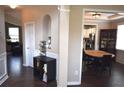 Open-concept design with a view to the kitchen with stainless steel appliances and dark hardwood flooring at 106 Puckett Ct, Canton, GA 30115