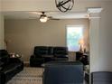 Bright living area with plush seating, a ceiling fan, and natural light from the windows at 106 Puckett Ct, Canton, GA 30115