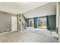 Spacious living room with fireplace, stairs, and doors leading to deck at 1057 Falling Water Se Dr, Smyrna, GA 30080