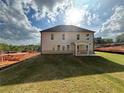 The back of the home has a covered patio and a large yard, ideal for outdoor activities at 6969 Melody Dr, Buford, GA 30518