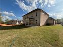 Newly sodded backyard view with a covered patio and ample space for outdoor enjoyment at 6969 Melody Dr, Buford, GA 30518