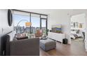 Bright living room with hardwood floors, large windows, and cozy seating area at 788 W Marietta Nw St # 403, Atlanta, GA 30318