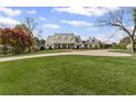 Charming two-story home featuring a well-manicured lawn and a circular driveway at 710 Cox Rd, Roswell, GA 30075