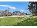 Beautiful home with lush lawn and mature trees on an expansive lot at 710 Cox Rd, Roswell, GA 30075