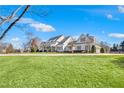 Spacious, white home featuring a large front lawn and classic architectural details at 710 Cox Rd, Roswell, GA 30075