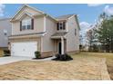 Two-story house with brick and siding, two-car garage, and landscaped yard at 527 Firethorn Ct, Villa Rica, GA 30180