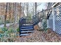 Black railings wooden stairs leading to deck at 1695 Bull Sw Run, Lilburn, GA 30047