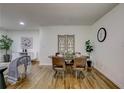 Bright dining area with hardwood floors, a stylish table, and decorative wall accents at 131 Brookwood Sw Dr, Marietta, GA 30064